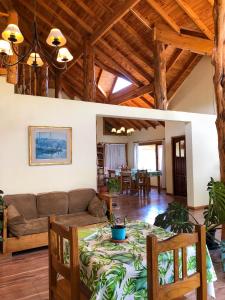 a living room with a table and a couch at La Estancia in Trevelín