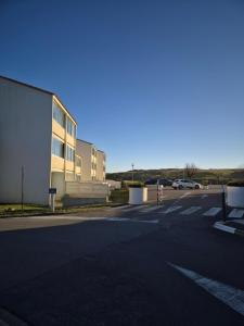 an empty parking lot next to a building at Welcome Becs! in Saint-Hilaire-de-Riez