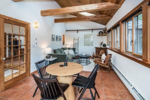 a living room with a wooden table and chairs at Mountain Top Fresh Pond Hot Tub in Pittsfield