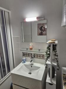a white bathroom with a sink and a mirror at Welcome Becs! in Saint-Hilaire-de-Riez +37 photos