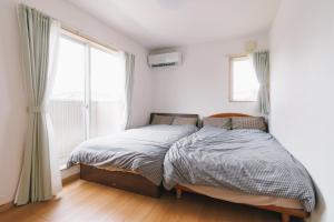 Giường trong phòng chung tại Lapacho 子どもが絶対満足する宿 民泊らぱちょ +52 ảnh