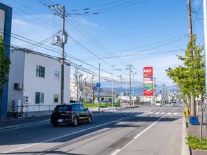 a car is driving down a city street at lol 3 201 in Hakodate