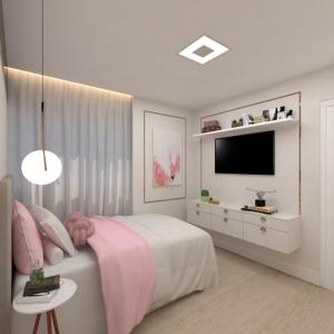 a white bedroom with a bed and a television at Hotel cabana in Magalhães Bastos
