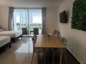 a living room with a table and a room with a bed at Town Center Playa Blan in Playa Blanca