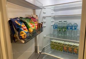 an open refrigerator filled with lots of food and drinks at Doncaster Penthouse Long Stays in Doncaster