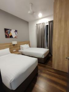 Ένα ή περισσότερα κρεβάτια σε δωμάτιο στο ComfyStays-sunwayonsen2br2b +17 φωτογραφίες