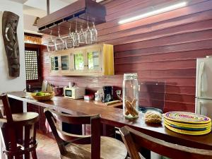 a kitchen with a table with chairs and a refrigerator at Appartement ATIALA in Hell-Ville +39 photos