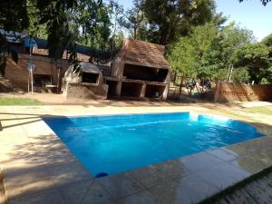 a swimming pool in a backyard with a pizza oven at El Paraíso in San Rafael