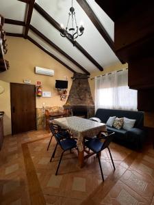 a living room with a table and a couch at Casas Rurales Carrizosa in Navaconcejo