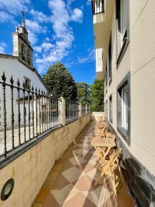 a row of benches sitting on the side of a building at The Cliffs - AT Seiramar in Viveiro +27 photos