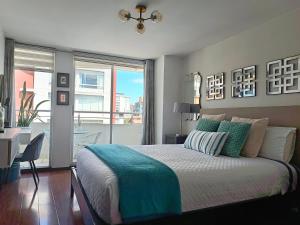 a bedroom with a bed and a desk and a window at CENTRAL Apartment, 3Beds - Balcony - Parking - 6thFLOOR in Quito +33 photos