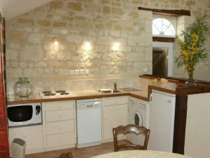 a kitchen with a sink and a stove at Gîte authentique au cœur de la forêt près de Chinon - FR-1-381-232 in Saint-Benoît-la-Forêt