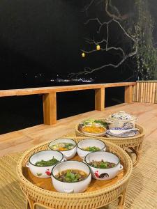 a table with bowls and plates of food on it at Chan Rak Khao Villa ฉันรักเขาวิลล่า in Ban Na Kham +48 photos