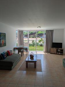 a living room with a couch and a table at N'JOK Papeete in Papeete