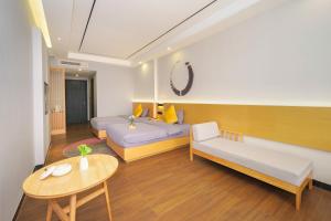Postel nebo postele na pokoji v ubytování Gong Xili Chujian Hotel Mengzi Branch
