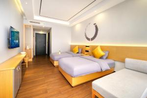 Postel nebo postele na pokoji v ubytování Gong Xili Chujian Hotel Mengzi Branch