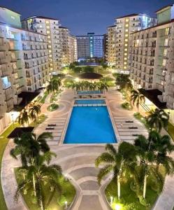 an overhead view of a resort with a pool and palm trees at Filed Residences Hotel Apartment in Manila