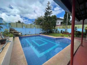 a swimming pool in a yard with a fence at Casa La Viva - house with pool in Tagaytay