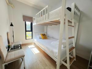 Postel nebo postele na pokoji v ubytování Baan Trin(บ้านตฤณ)