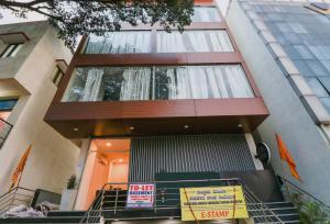 a building with a sign in front of it at Capital O GN Suites in Bengaluru