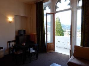 a living room with a table and a large window at Appartement 3 pièces avec terrasse et parking à Jausiers - FR-1-804-24 in Jausiers +3 photos