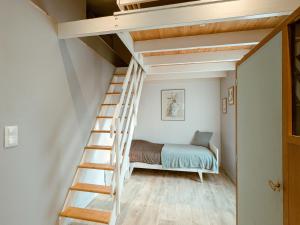a room with a bunk bed and a ladder at Maison indépendante avec terrasse et parking privatif - FR-1-591-719 in Le Poinçonnet