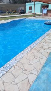 a swimming pool with blue water at Villa MAS - Condominio Hacienda II in Pachacamac