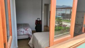 a room with a bed and a view of the ocean at Villa MAS - Condominio Hacienda II in Pachacamac