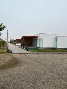 a building on the side of a road at Linda Casa en Condominio in Asia +17 photos