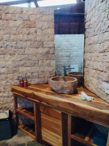 a bathroom with a wooden counter with a sink at Turrall Bungalow in Puyung