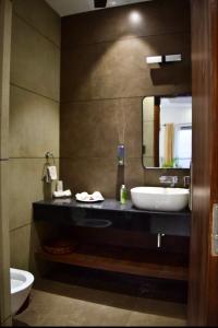 a bathroom with a sink and a mirror at Haven farmstays in Amritsar +24 photos