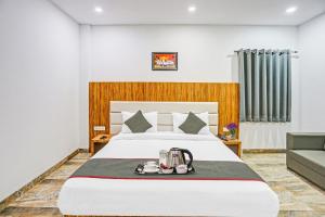 a hotel room with a bed and a couch at Townhouse Super Two Premium in Varanasi
