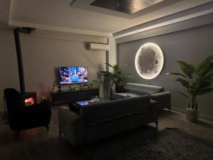 a living room with a couch and a tv at Villa akça in Masukiye