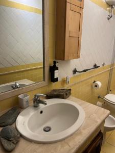 a bathroom with a sink and a toilet at Tuscia Home Backpackers in Orte
