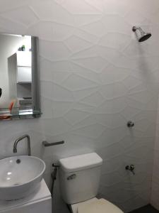 a bathroom with a white toilet and a sink at Scandinavian Studio with Highspeed internet in Bantug +9 photos