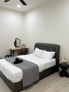 a bedroom with a bed with a black and white blanket at Jan2025 New Reno De Blackwood Home in Port Dickson +16 photos