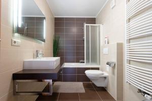 a bathroom with a sink and a toilet and a shower at Topfloor Luxembourg Ville in Luxembourg +24 photos