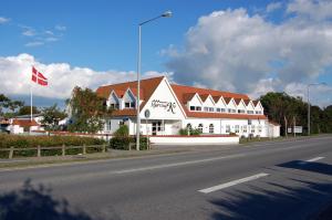 a large white building on the side of a road at Hjørring Kro in Hjørring