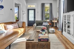 a living room with a couch and a coffee table at Pleasure Pier Modern Home Nr Beach Bbq Games in Galveston +26 photos