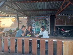 a group of people sitting at a table in a restaurant at Bintang Senaru Inn in Senaru
