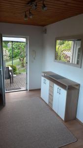 a living room with a counter and a sliding glass door at Ferienhaus im Grünen-Idyllischen Lage in Suhl +10 photos