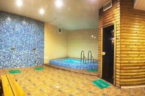 a bathroom with a swimming pool in a room with tiles at Hostel VIP Na Pestelya, 11 in Vinnytsya