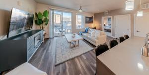 a living room with a couch and a table at Expansive views - 1BD 1BA Hot Tub, Pool, Convention Centre in Salt Lake City +35 photos
