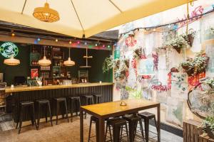a restaurant with tables and a bar with graffiti at Story Hotel Riddargatan, part of JdV by Hyatt in Stockholm