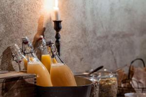 a group of bottles of orange juice on a table at Story Hotel Riddargatan, part of JdV by Hyatt in Stockholm