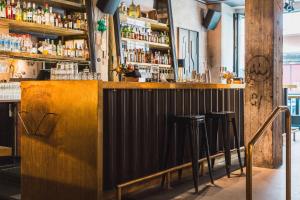 a bar in a restaurant with stools at Story Hotel Riddargatan, part of JdV by Hyatt in Stockholm