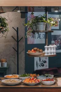 a buffet with plates of food on a table at Story Hotel Riddargatan, part of JdV by Hyatt in Stockholm