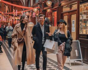 three people walking down a street in a store at Story Hotel Riddargatan, part of JdV by Hyatt in Stockholm