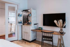 a room with a desk and a tv on a wall at Story Hotel Riddargatan, part of JdV by Hyatt in Stockholm