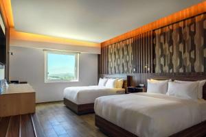 Postel nebo postele na pokoji v ubytování Radisson Puebla Angelopolis + 37 fotografií